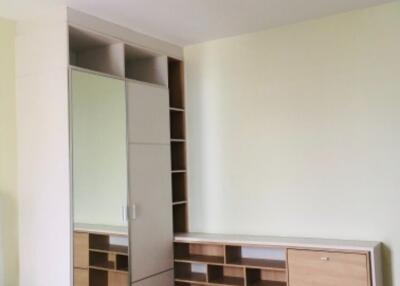 Modern bedroom with built-in wardrobe and mirror