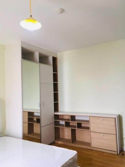 Modern bedroom with built-in wardrobe and mirror