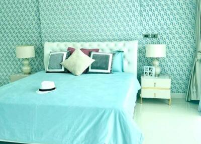 Well-lit bedroom with turquoise theme and stylish decor