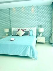 Well-lit bedroom with turquoise theme and stylish decor