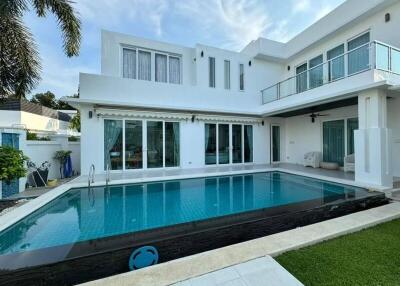 Modern white two-story house with outdoor pool