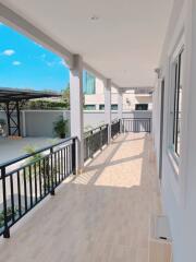 Spacious balcony with railings and tiled floor