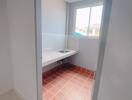 Laundry room with a window and tiled floor