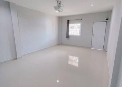 Spacious living room with white walls and large windows