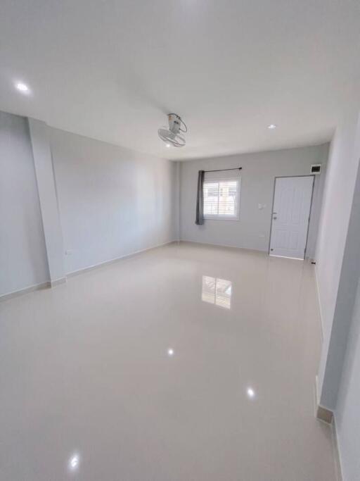 Spacious living room with white walls and large windows