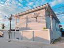 Exterior view of the house with a fence and street view