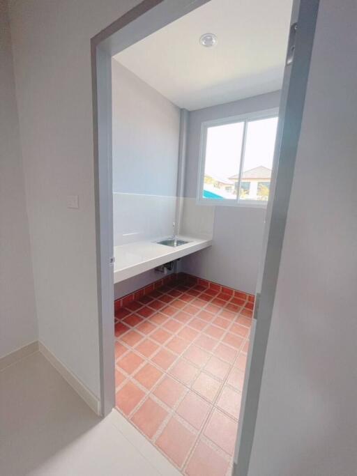 Laundry room with sink and window