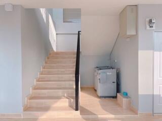 utility area with stairs and washing machine