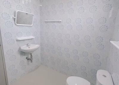 Modern bathroom with patterned tile wall