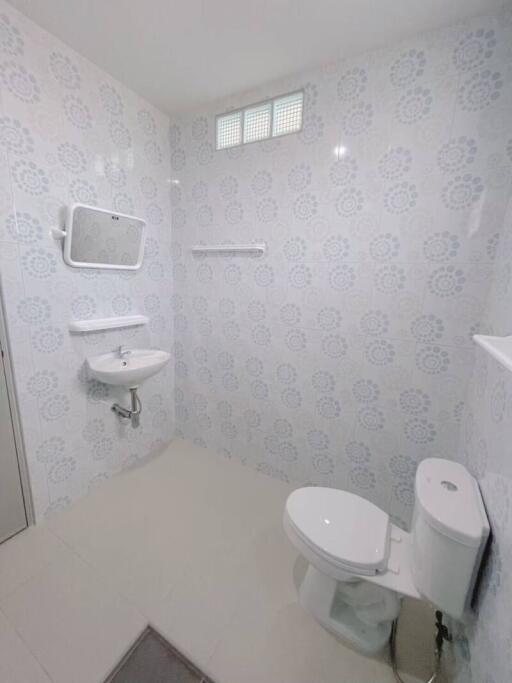 Modern bathroom with patterned tile wall