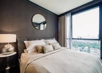 Modern bedroom with large windows and city view