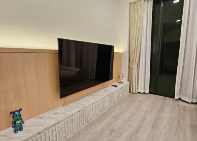 Modern living room with wall-mounted TV and sliding glass doors