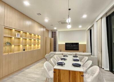 Modern living and dining area with wooden cabinetry