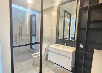 Modern bathroom with glass shower enclosure and large mirror