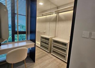 Modern walk-in closet with desk and chair