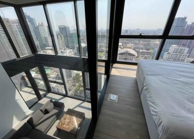 Modern high-rise apartment with floor-to-ceiling windows showing a cityscape view