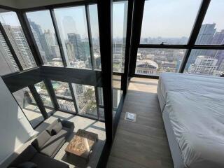 Modern high-rise apartment with floor-to-ceiling windows showing a cityscape view