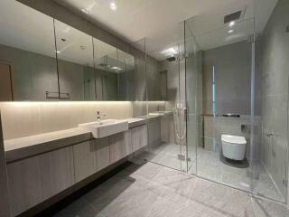 Modern bathroom with glass shower and large mirror