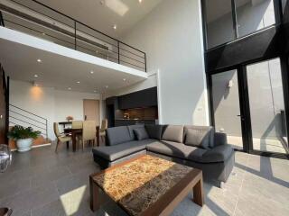 Modern living room with high ceiling and balcony