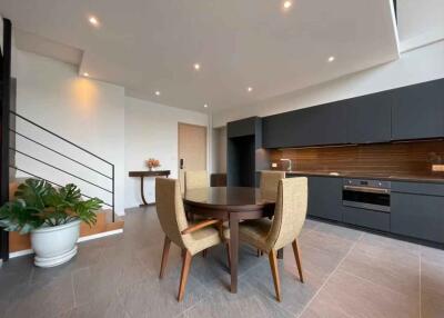 Modern open concept kitchen and living area with dining table