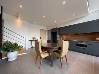 Modern open concept kitchen and living area with dining table