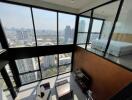 High-rise apartment with large windows, city view, and mezzanine bedroom