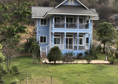 Beautiful blue two-story house with a large yard