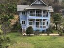 Beautiful blue two-story house with a large yard