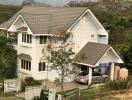 Two-story house with an attached garage and surrounding greenery