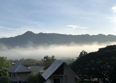 View of foggy mountains from a rooftop