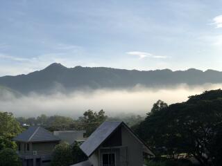 View of foggy mountains from a rooftop