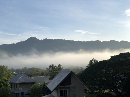 View of foggy mountains from a rooftop