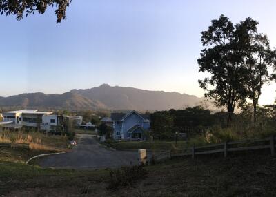 A scenic view of a residential neighborhood with mountains in the background