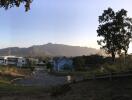 A scenic view of a residential neighborhood with mountains in the background