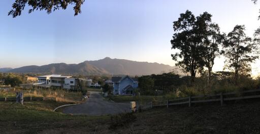 A scenic view of a residential neighborhood with mountains in the background