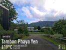 A picturesque residential neighborhood in Tambon Phaya Yen with lush greenery and mountains in the background.