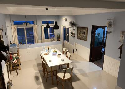 Cozy dining area with a table set for a meal and multiple chairs