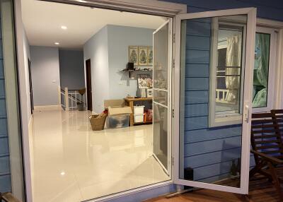 A spacious and organized living area with white tile floors