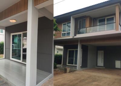 Modern two-story house exterior with balcony and covered parking area