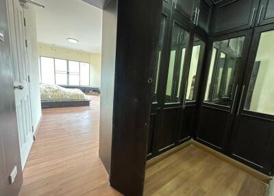 Well-lit bedroom with large windows and a walk-in closet