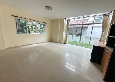 Spacious living room with large windows and natural light