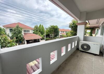 Spacious balcony with a view of neighboring houses and greenery