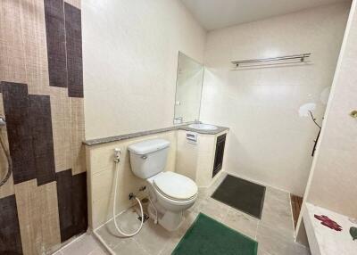 Spacious modern bathroom with toilet, sink, and shower area