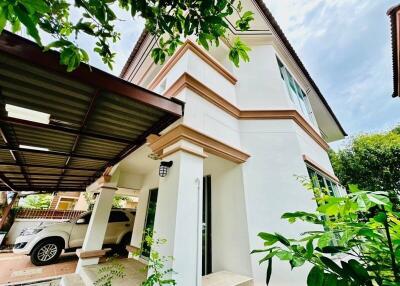 Exterior view of a residential house with a carport