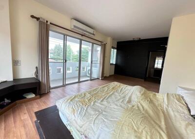 Spacious bedroom with large windows and balcony access