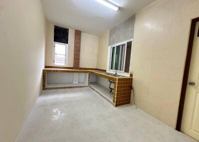 Simple kitchen with tiled countertops and window