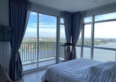 Bedroom with large windows and a scenic view