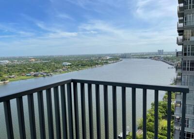 Balcony with a view of a river and surrounding landscape