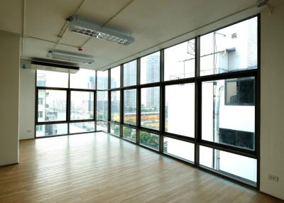 Spacious empty room with large windows and city view