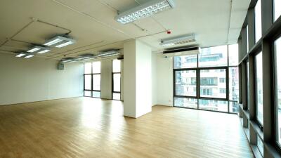 Spacious open-plan living area with large windows